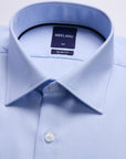 Light blue dress shirt with collar and brand label on a light gray background